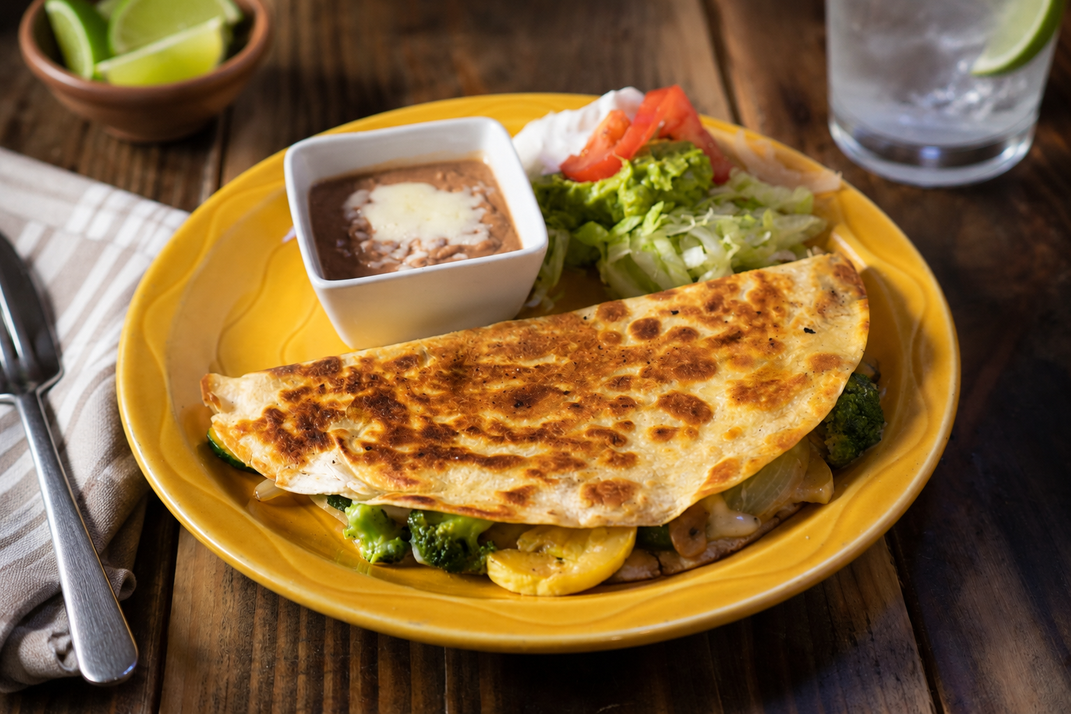 Veggie quesadilla with refried beans and salad