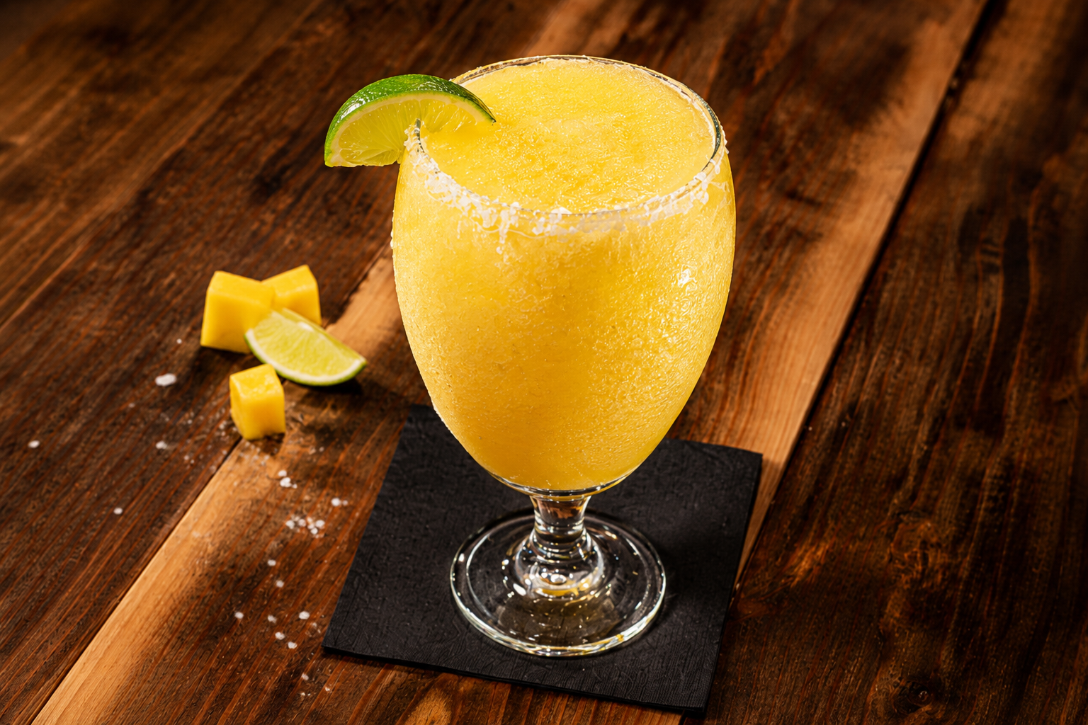 Frozen mango margarita with lime wedge